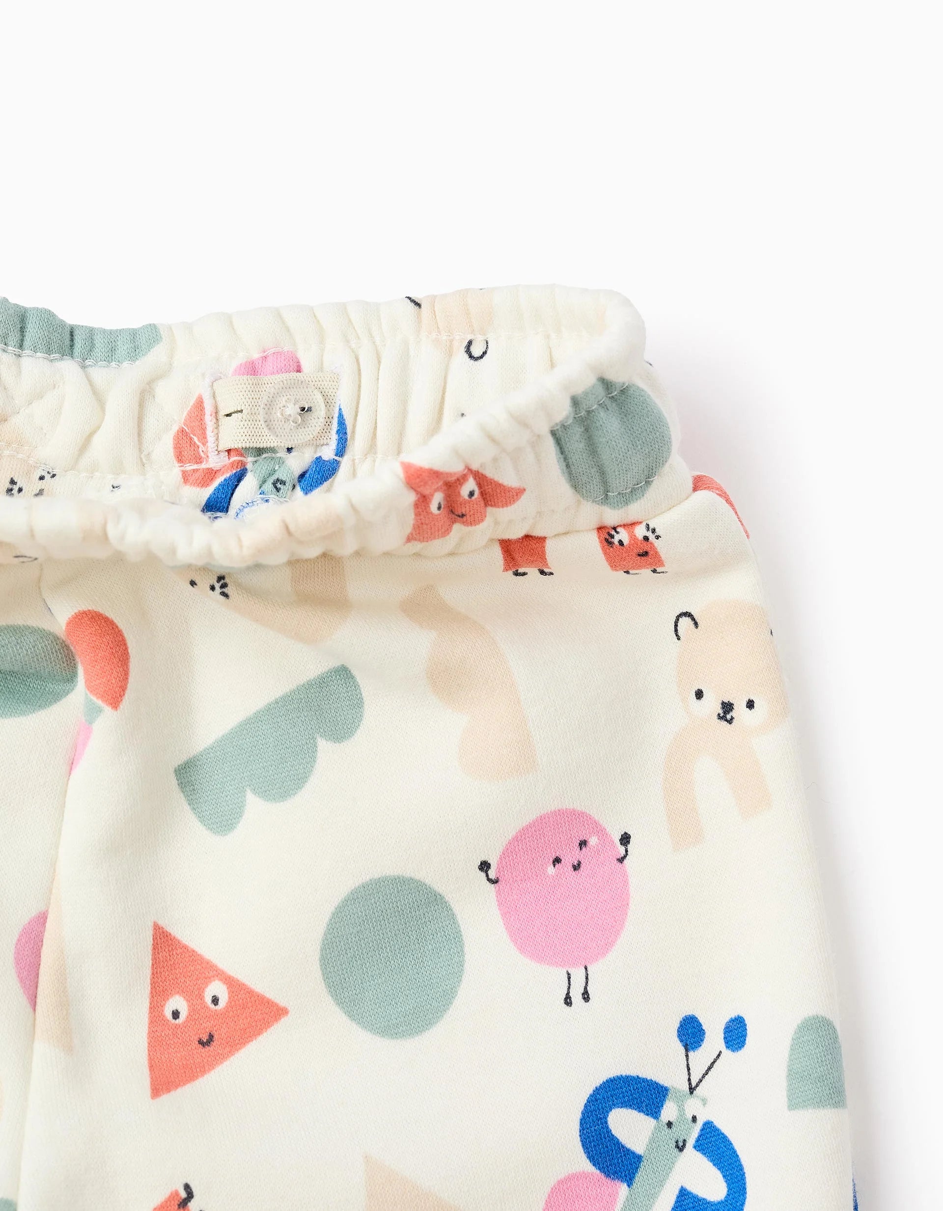 Fluted jogger pants with a 'Shapes' pattern for baby girls, white.