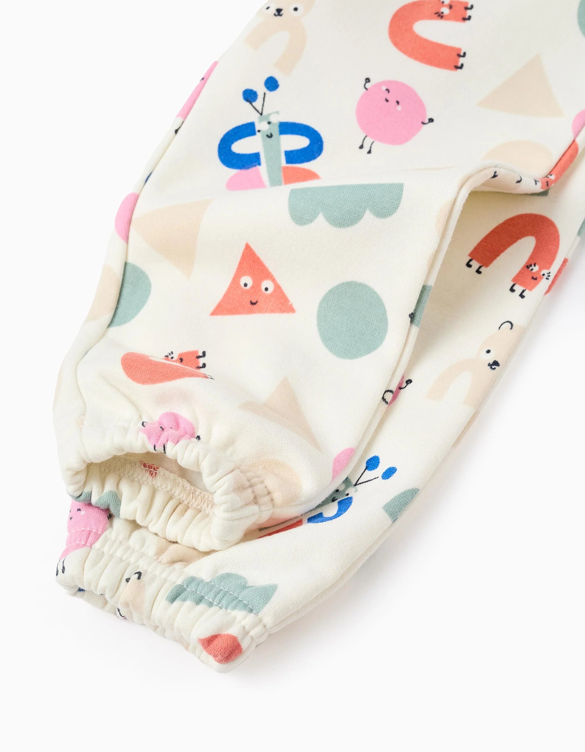 Fluted jogger pants with a 'Shapes' pattern for baby girls, white.